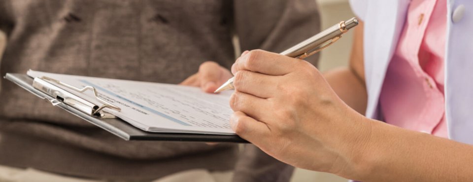 Someone filling in a HS / CQC inspection questionnaire and assessing garden leave