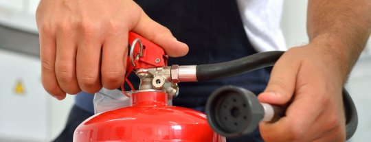 Person using a fire extinguisher