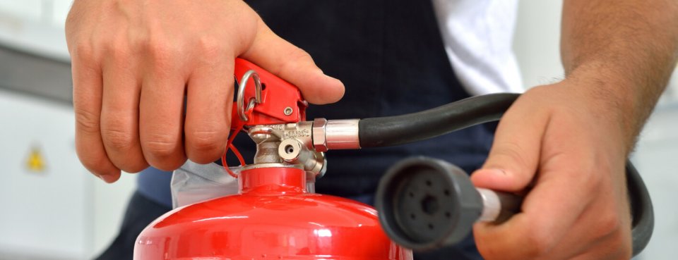 Person using a fire extinguisher