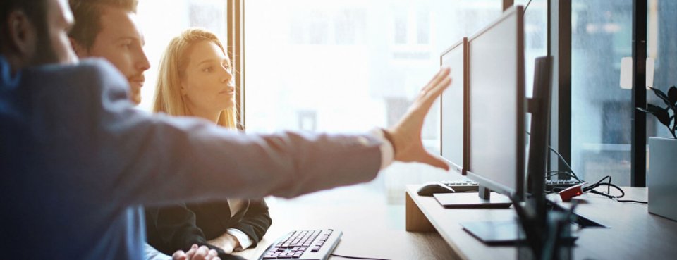 People looking at PC screens