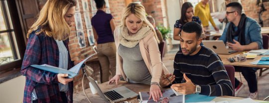 Pregnant lady at work with colleagues