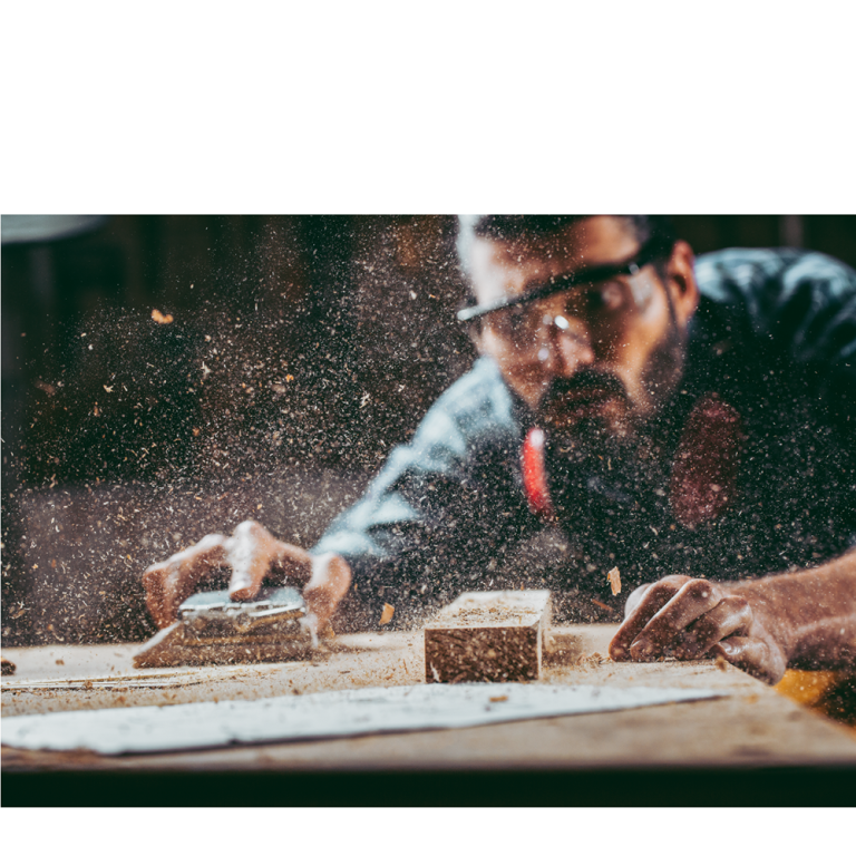 Woodwork creating MDF dust with a man in PPE for eyes