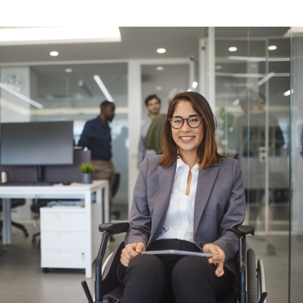Employee in wheelchair smiling due to reasonable adjustments being made in the workplace