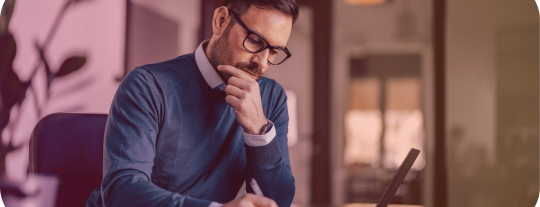 A man working on a laptop at a desk.